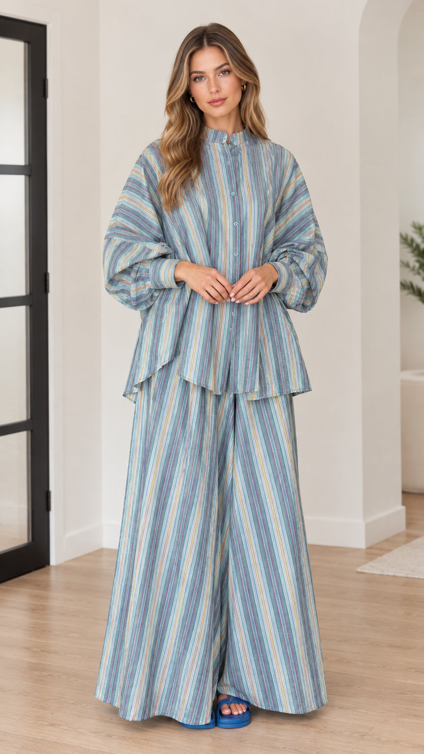 Front view of woman wearing blue vertical striped tunic top and wide leg pants set
