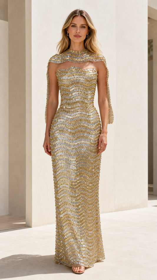 Front view of model wearing gold sequin strapless gown with matching shrug