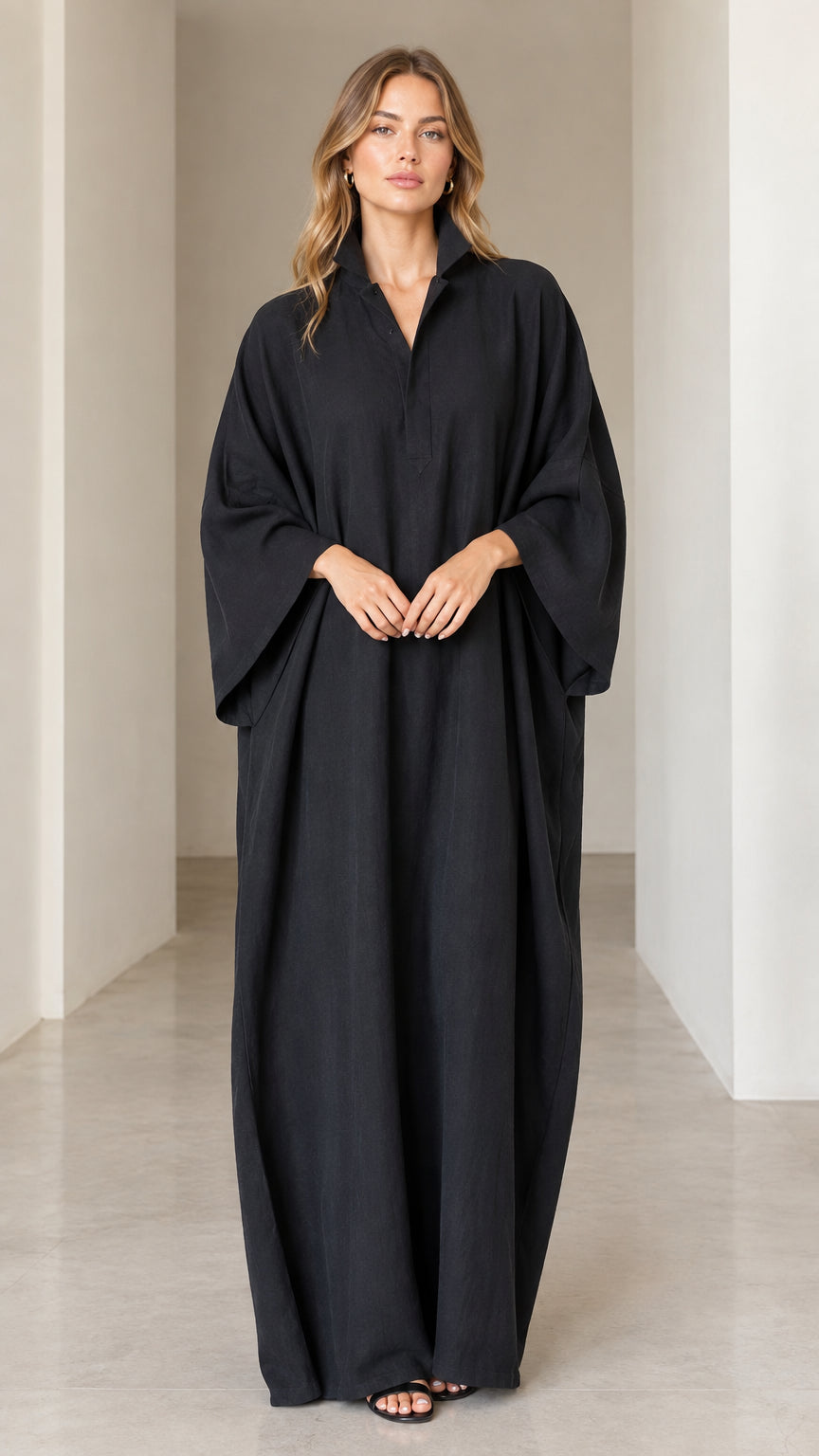 Front view of model wearing black oversized collared maxi kaftan dress