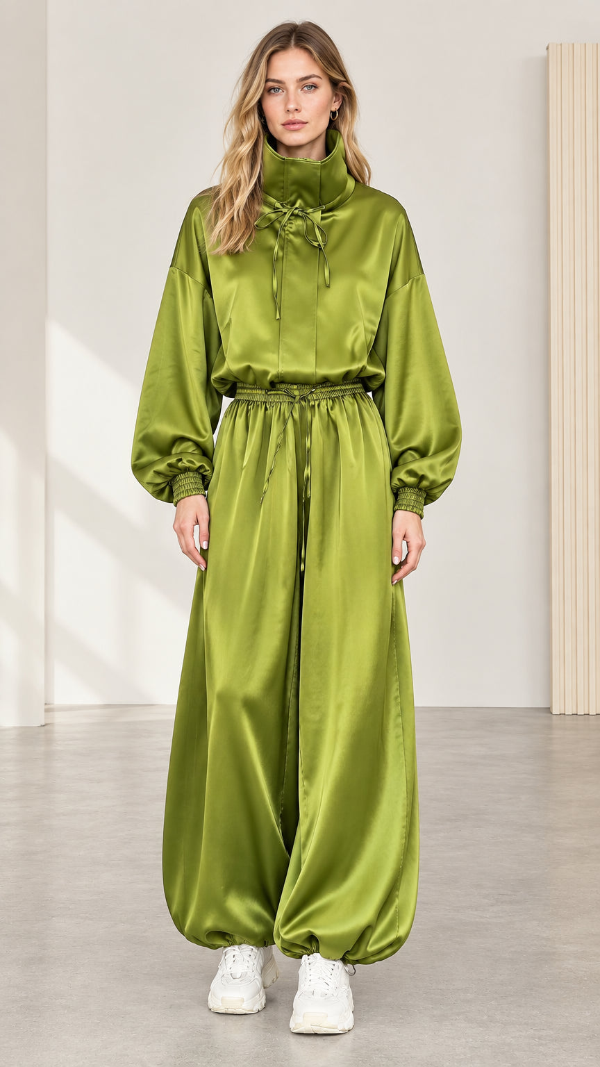 Full front view of model wearing olive green satin high neck jumpsuit with balloon legs