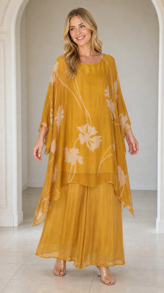 Front view of woman wearing mustard yellow floral kaftan set