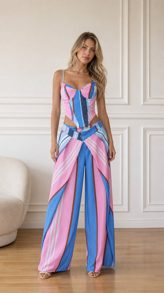 Front view of model wearing pink multi striped corset crop top and wide-leg pants set