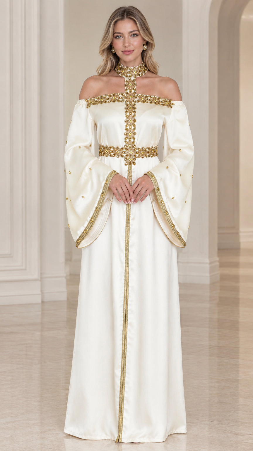 Front full-length view of woman wearing ivory satin off-shoulder maxi dress with gold embellishments