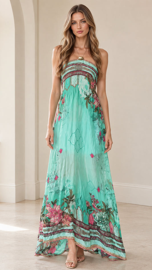 Front view of woman wearing turquoise strapless floral maxi dress with embellished neckline