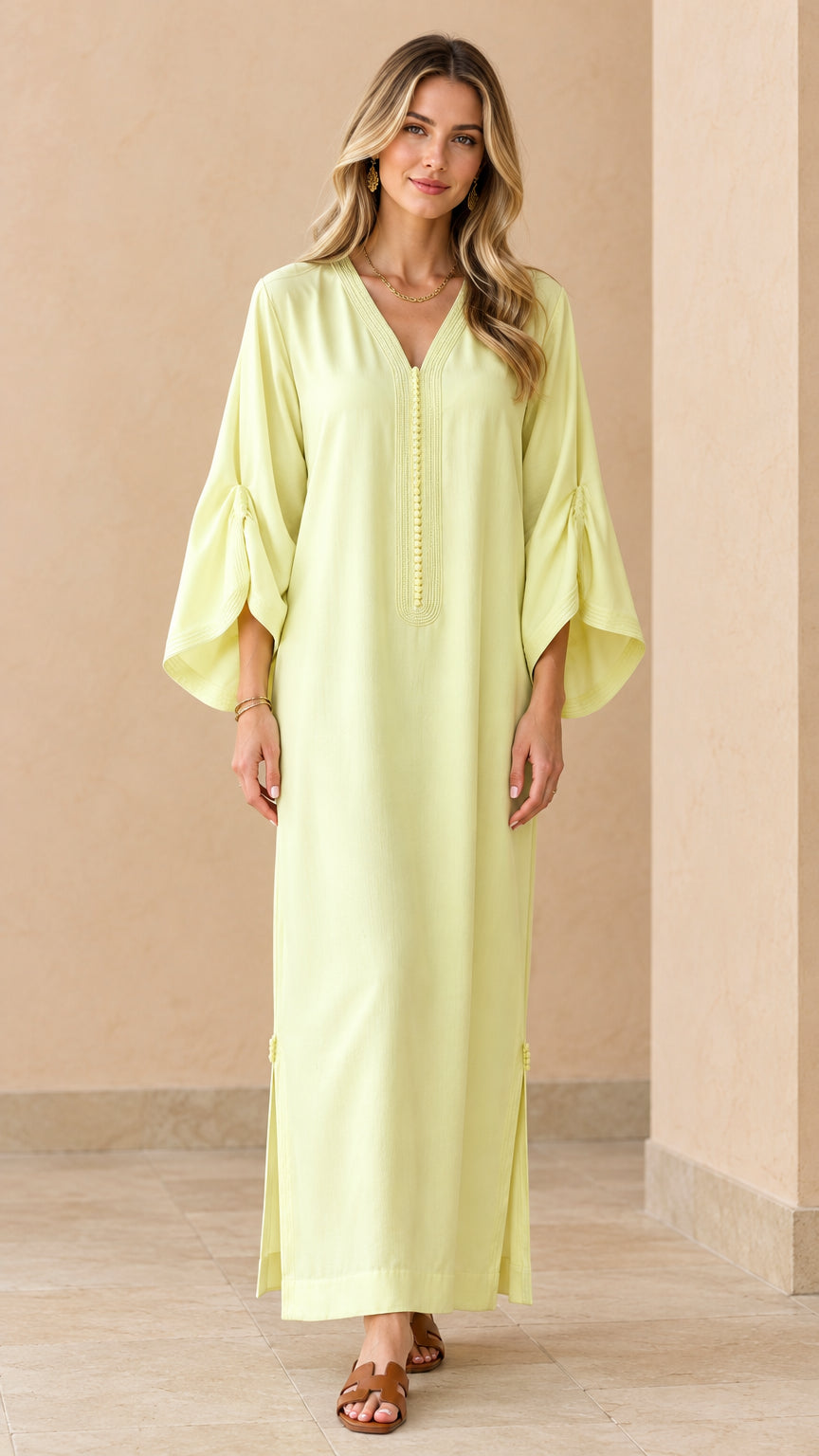 Front full view of woman wearing pale yellow bell sleeve kaftan maxi dress