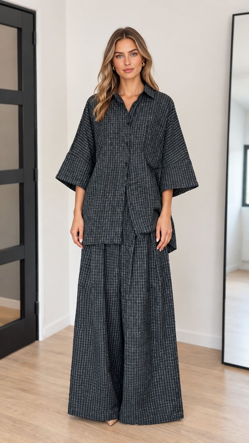 Front view of model wearing charcoal textured oversized shirt and wide leg matching pants set