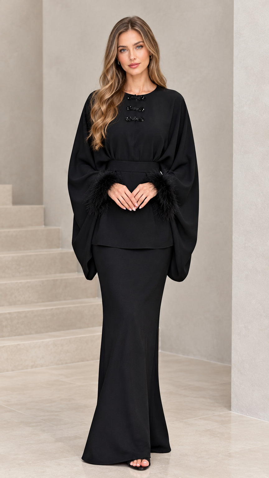 Full front view of model wearing black feather-cuff batwing tunic and maxi skirt set