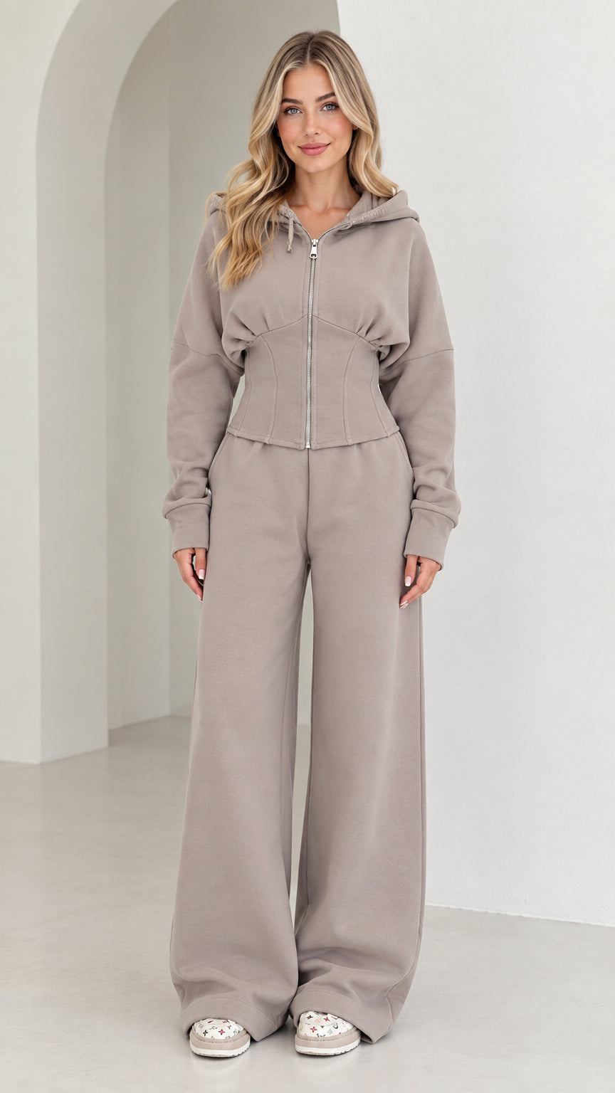 Front full-length view of woman wearing taupe corset zip-up hoodie and wide-leg sweatpants