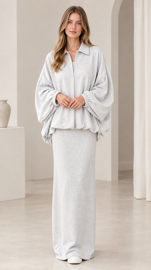 Front view of model wearing heather grey zip-front blouson jacket and maxi skirt set