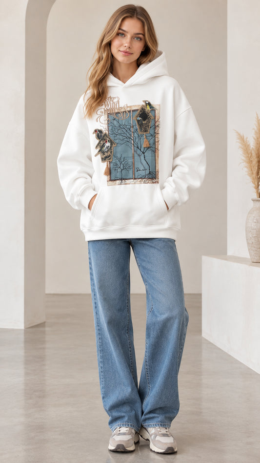 Front full view of woman wearing white vintage bird graphic pullover hoodie with wide leg jeans