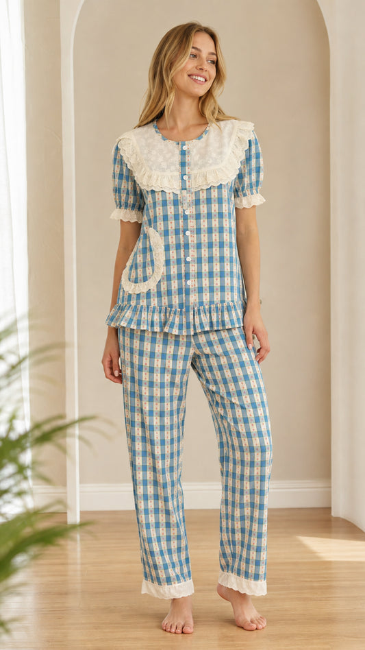Front view of model wearing blue gingham short sleeve pajama set with embroidered lace collar
