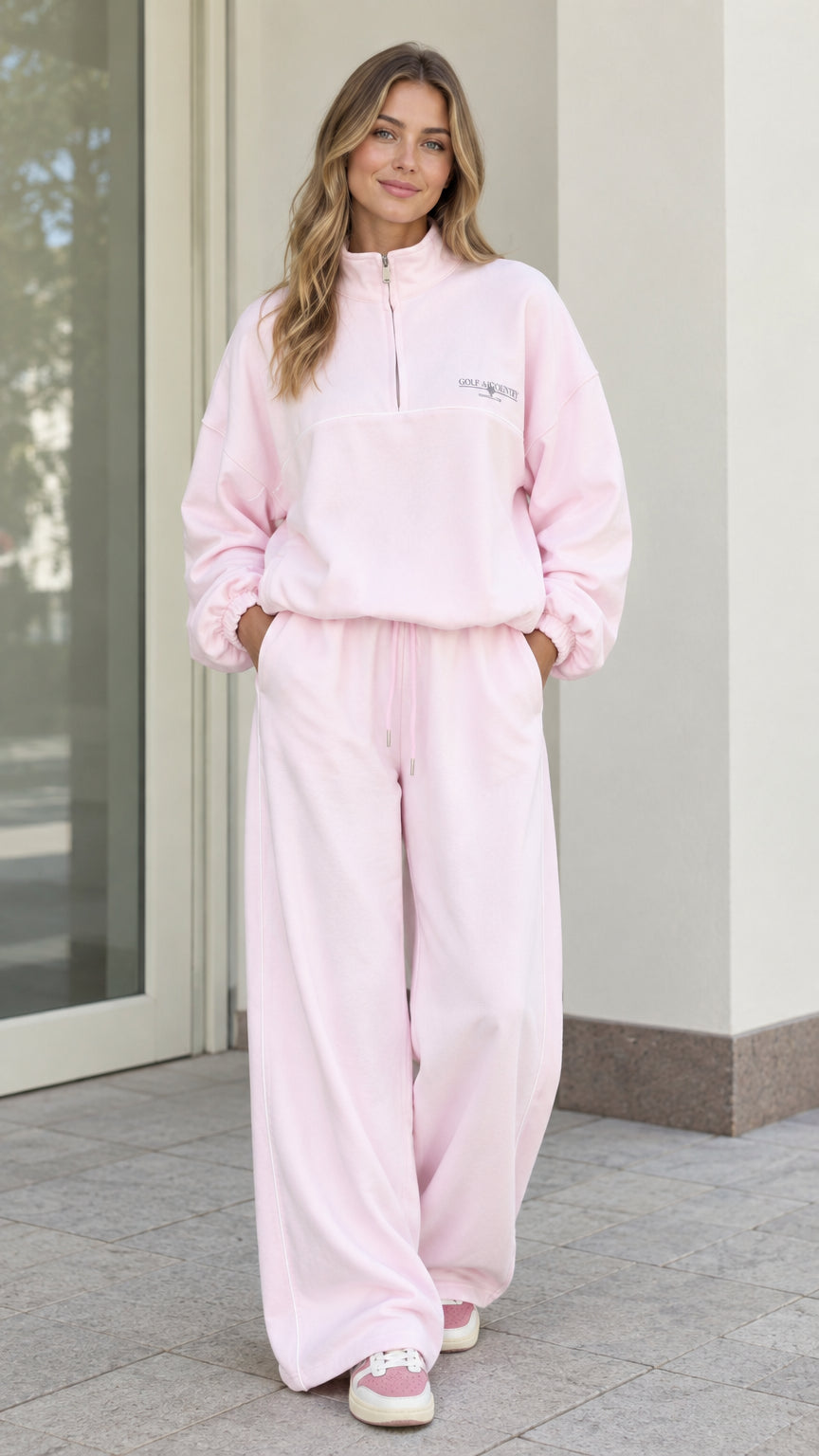 Front full view of woman wearing Light Pink fleece quarter-zip pullover and matching wide-leg pants set