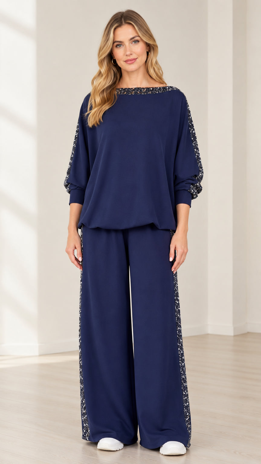 Front view of woman wearing navy blue 2-piece sequin trim top and wide leg pants set