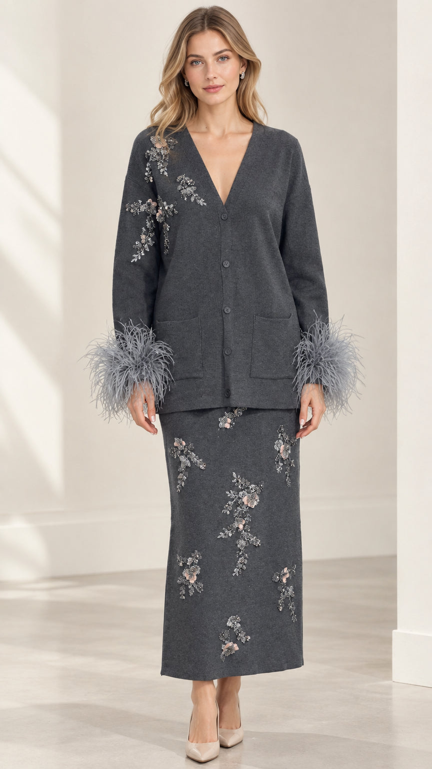 Front view of model wearing Charcoal Grey embellished cardigan and maxi skirt set with feather cuffs