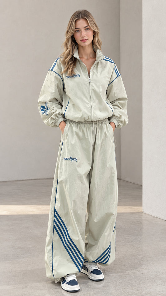Front view of woman wearing sage green retro two-piece windbreaker tracksuit set