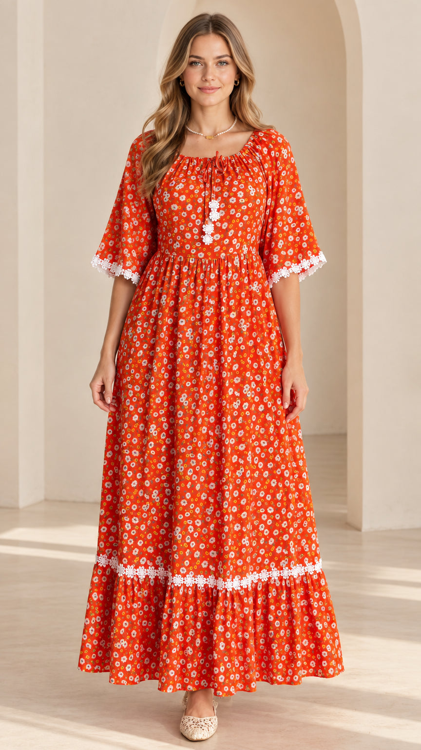 Front view of model wearing rust orange floral tiered maxi dress with lace trim