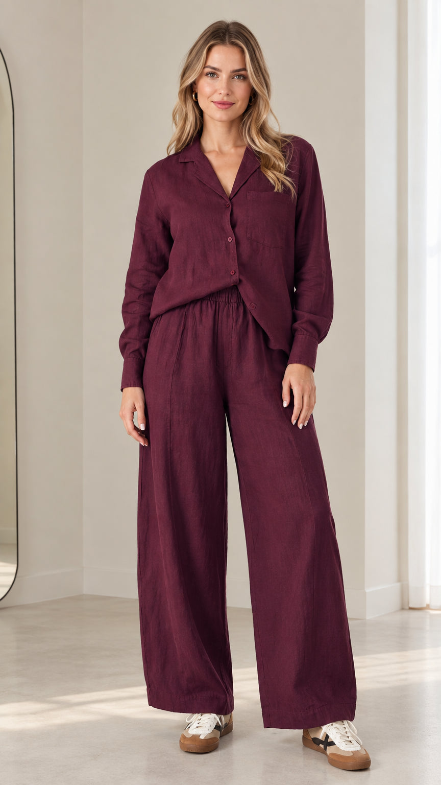 Full front view of model wearing burgundy two-piece button-down shirt and wide-leg pants set