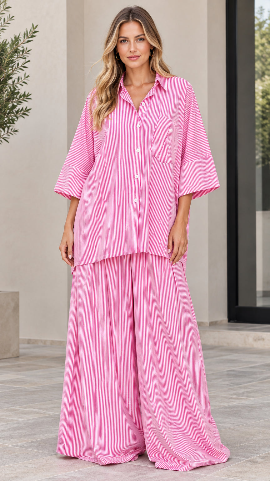 Front view of woman wearing pink and white striped oversized shirt and wide-leg pants set