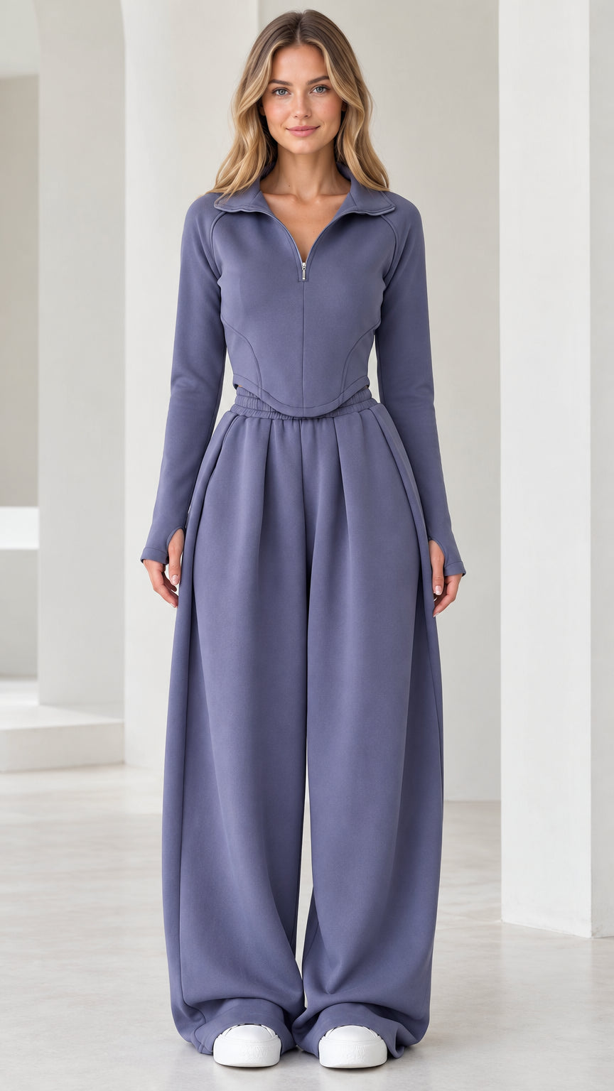 Front full-length view of model wearing dusty blue quarter-zip top and pleated wide-leg pants set