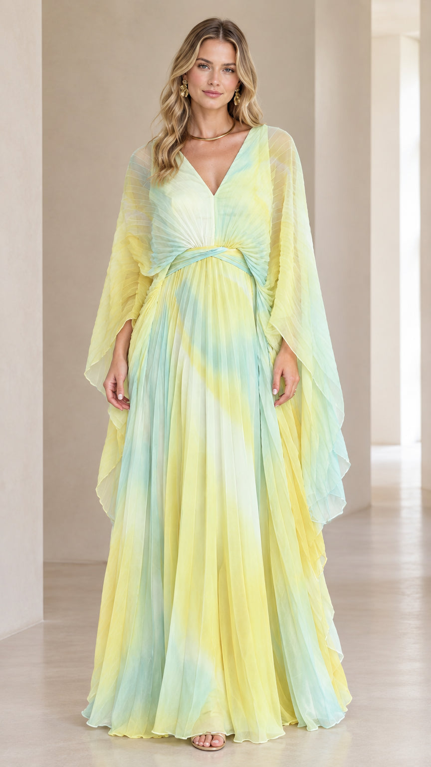 Front view of woman wearing yellow and mint green ombre pleated cape sleeve maxi dress