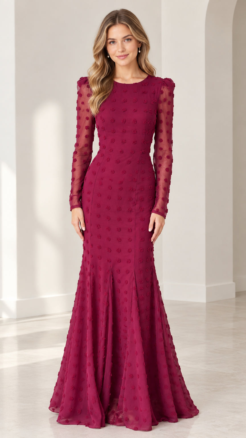 Full front view of model wearing burgundy long sleeve swiss dot mermaid evening gown