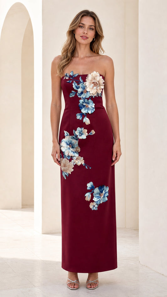 Front view of burgundy strapless maxi dress with 3d floral appliques