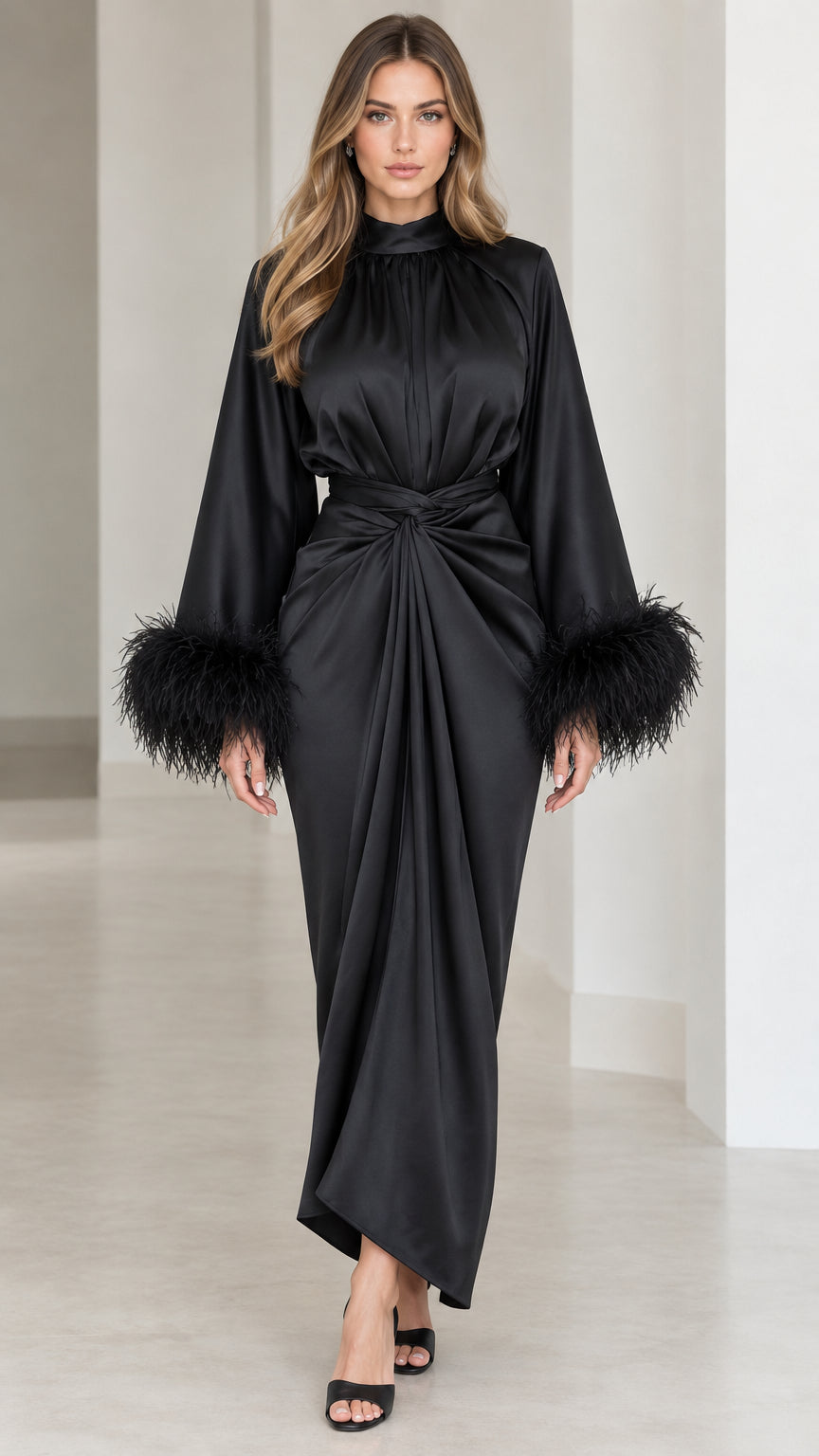 Front view of model wearing black satin mock neck maxi dress with feather cuffs