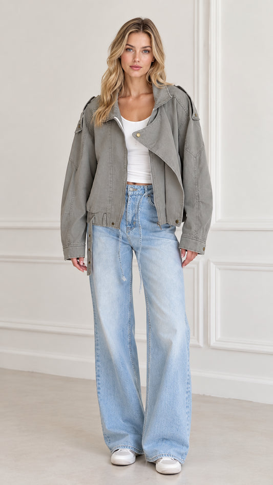 Front view of model wearing Sage Green washed twill utility moto jacket with wide-leg jeans