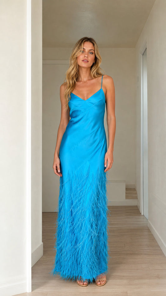 Front view of woman wearing bright blue satin feather trim maxi dress