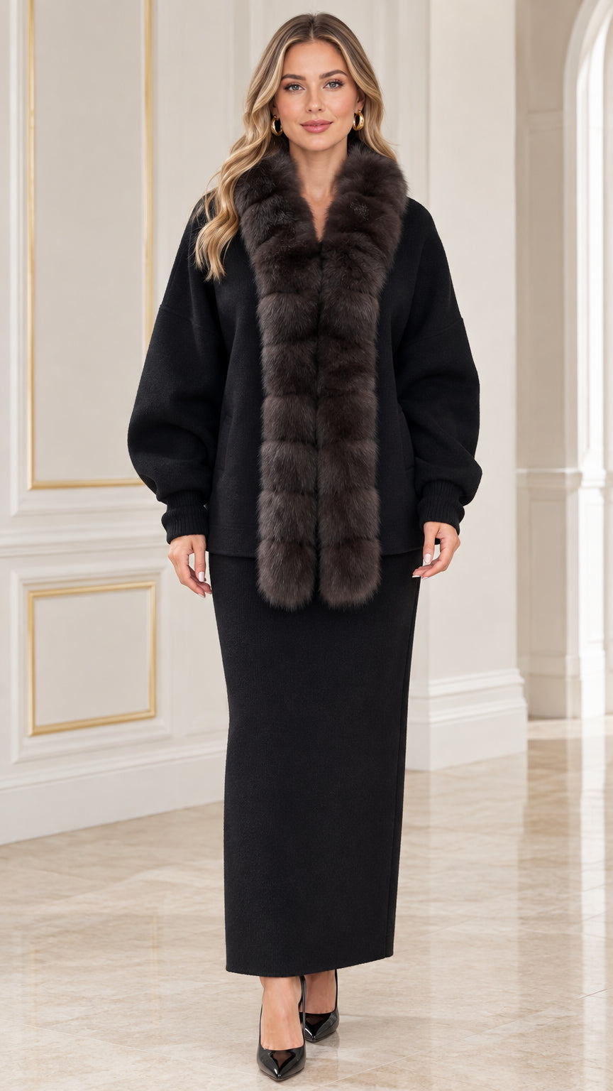 Front view of model wearing black faux fur collar cardigan and matching maxi skirt set