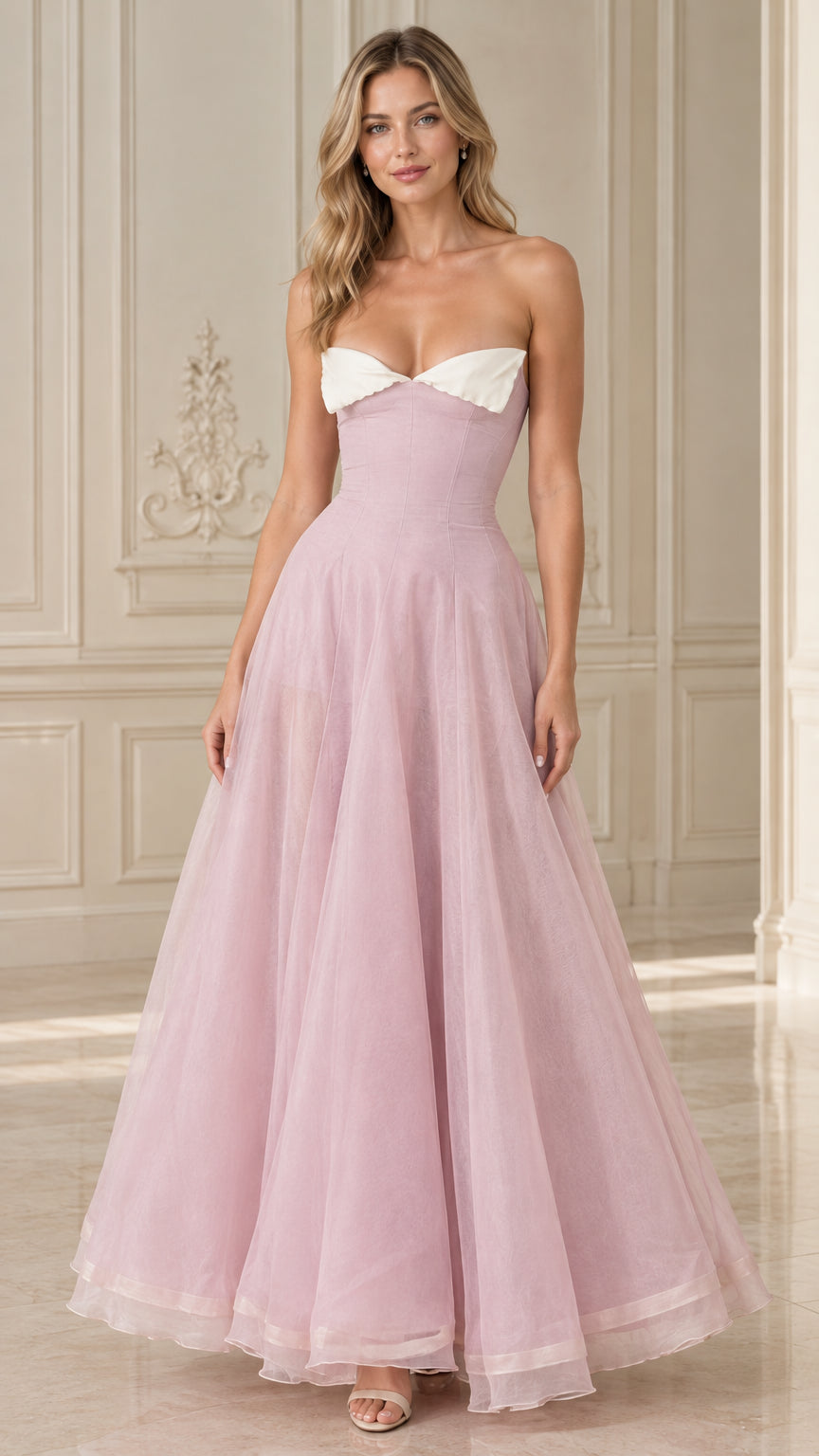 Front view of model wearing Blush Pink strapless formal evening gown with white contrast foldover neckline