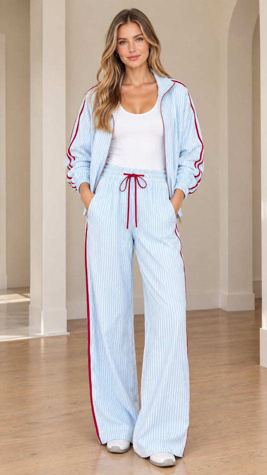 Front view of model wearing light blue striped track jacket and matching wide-leg pants set