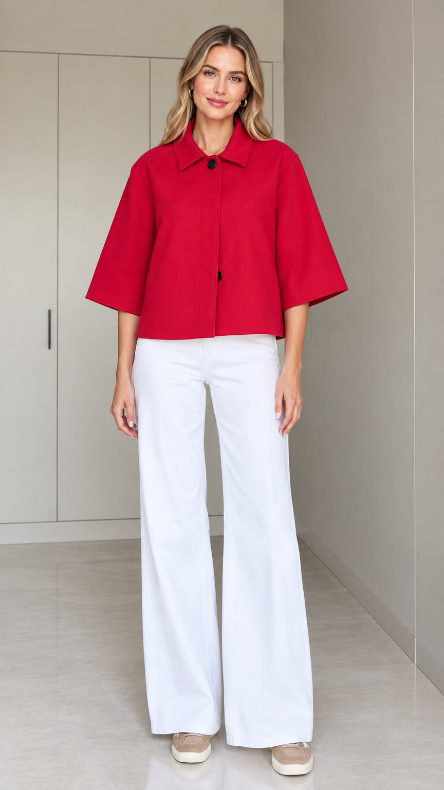 Front full-length view of a woman wearing a red cropped half-sleeve swing jacket with white wide-leg trousers