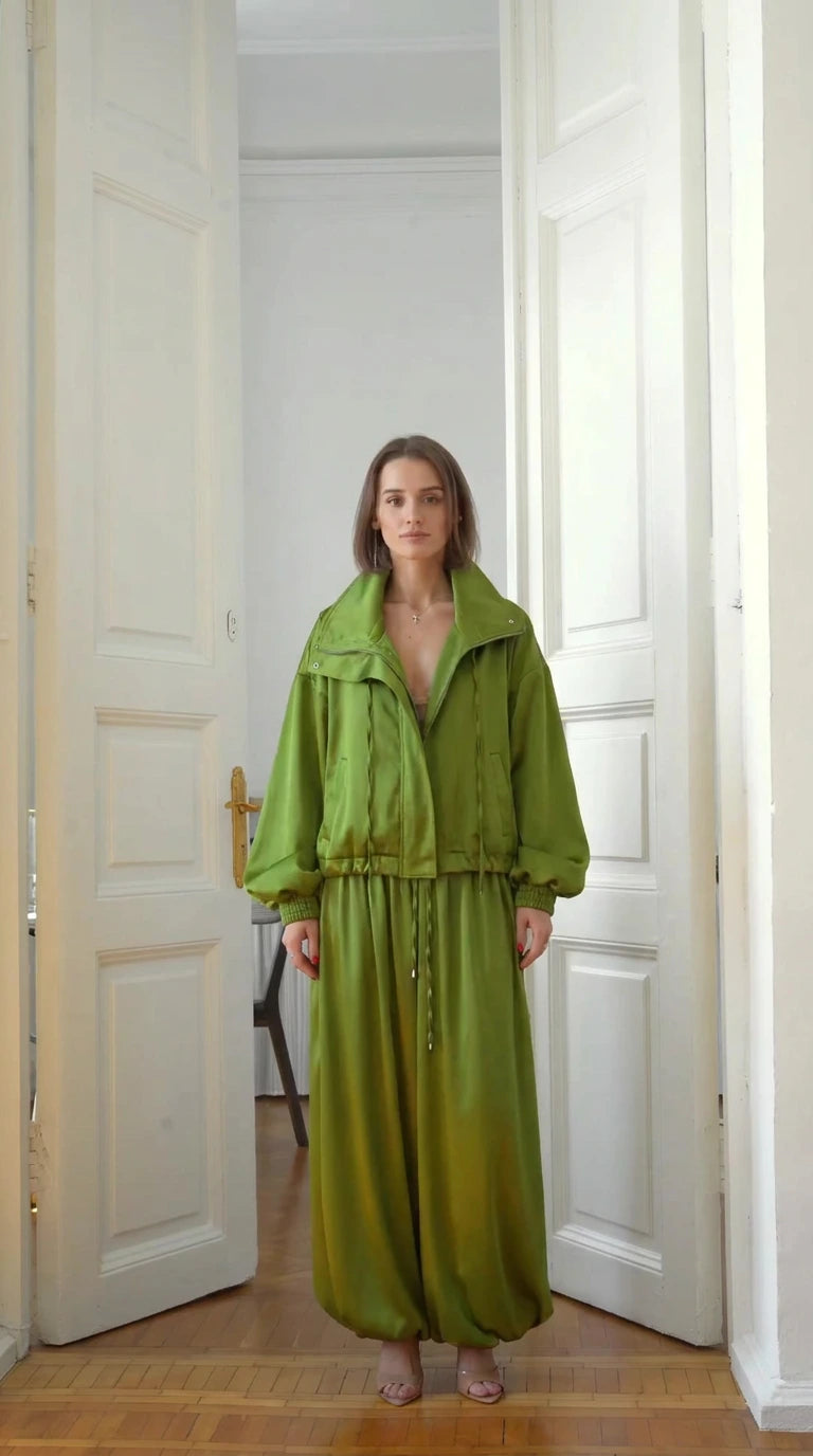 Full front view of model wearing lime green zip-up jacket and balloon pants two-piece set