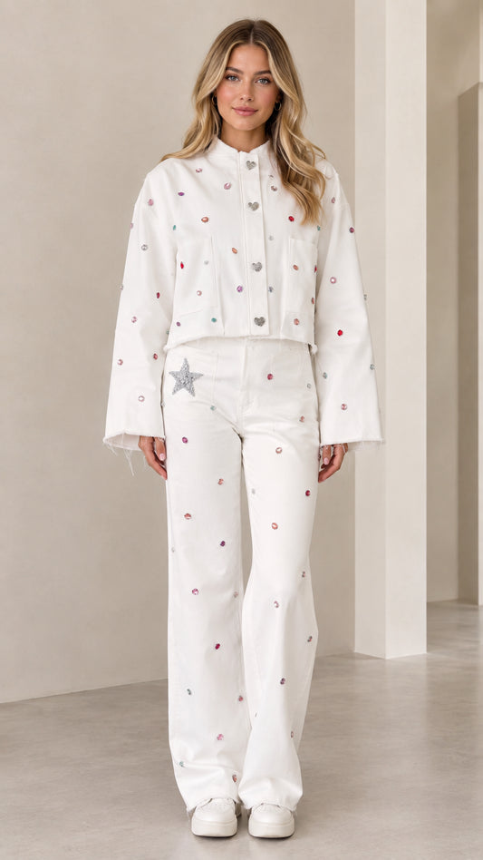 Front full view of woman wearing white rhinestone embellished cropped jacket and matching wide-leg pants