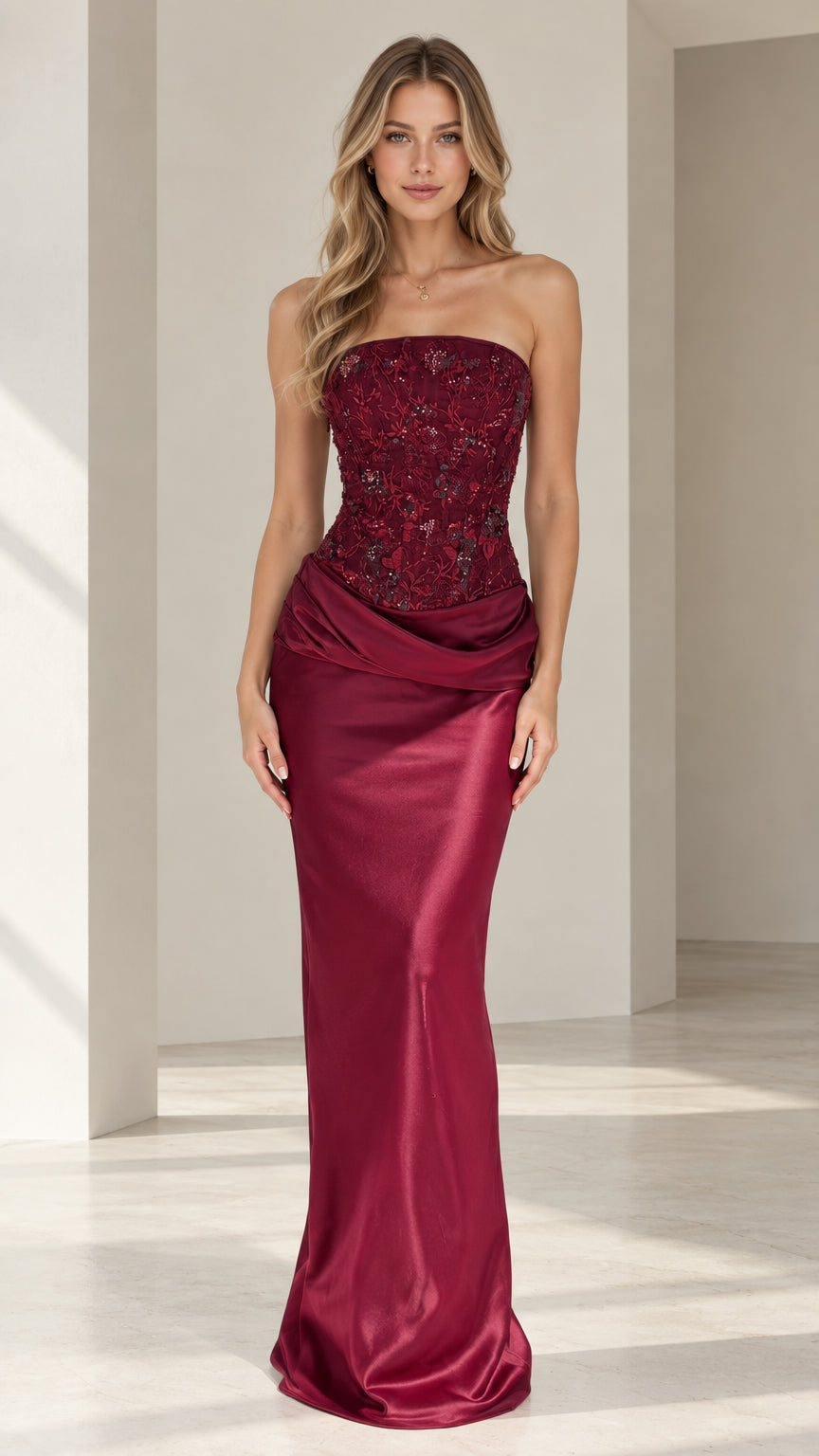 Front view of model wearing burgundy strapless beaded corset satin evening gown