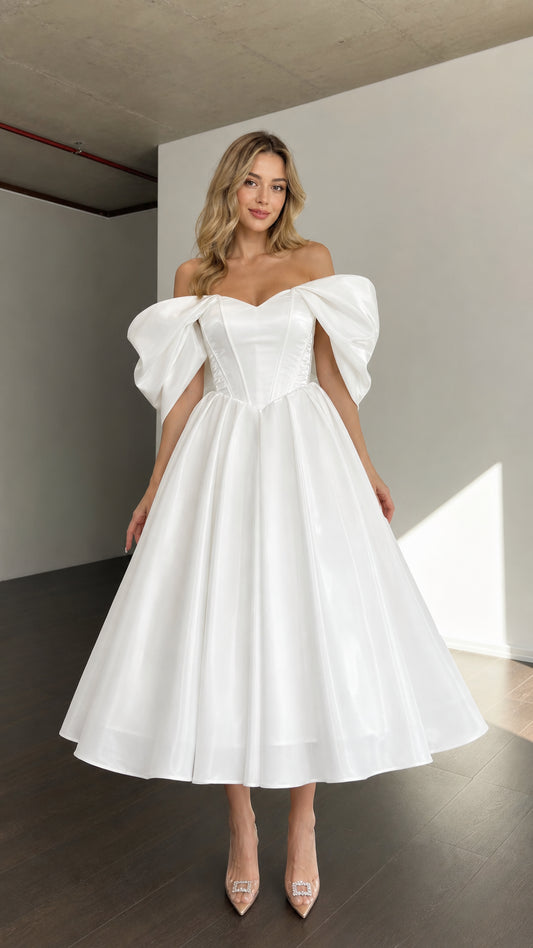 Front view of woman wearing white off-shoulder corset midi dress with puffy sleeves