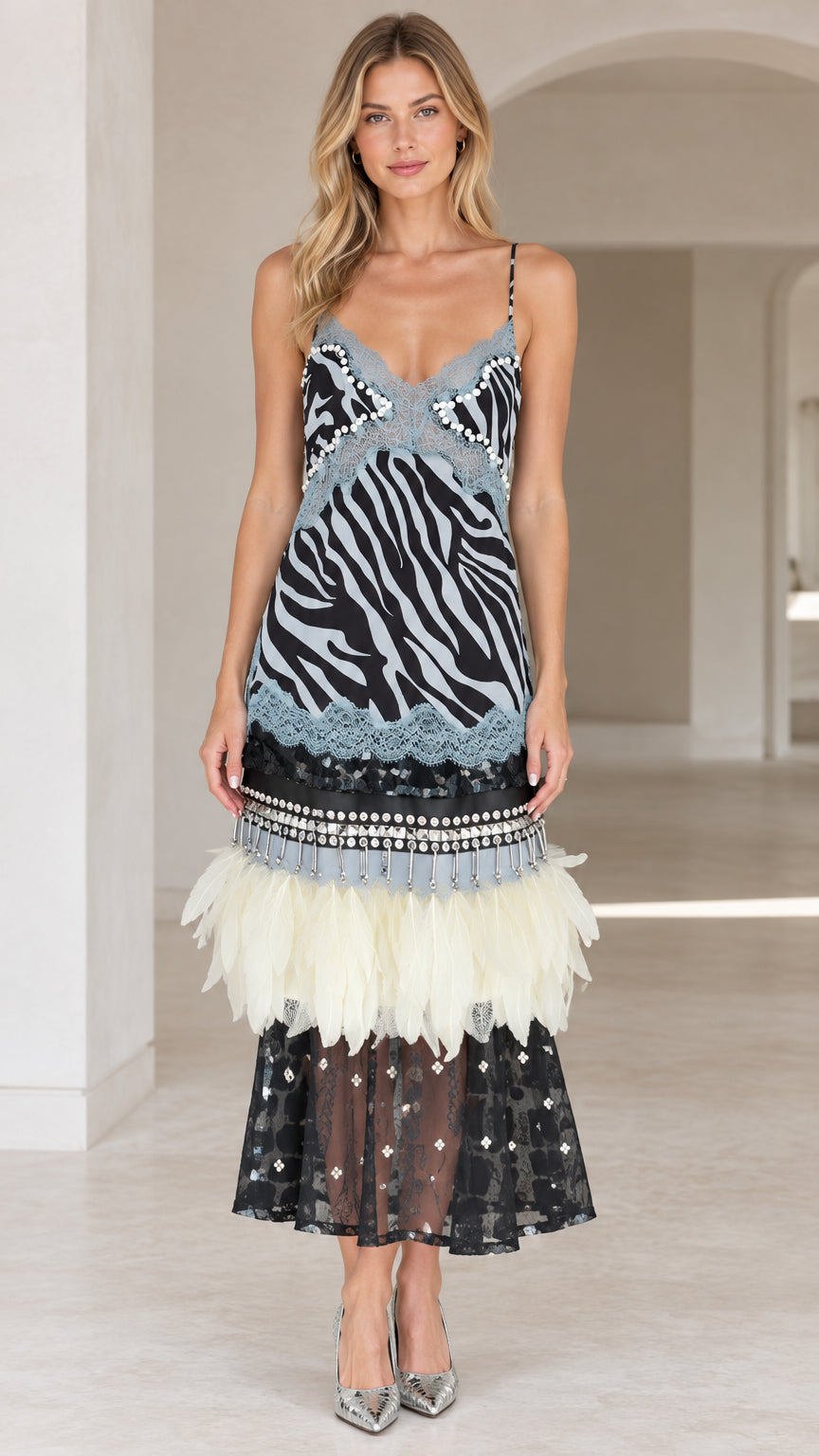 Front view of model wearing zebra print cami midi dress in black with feather and lace hem