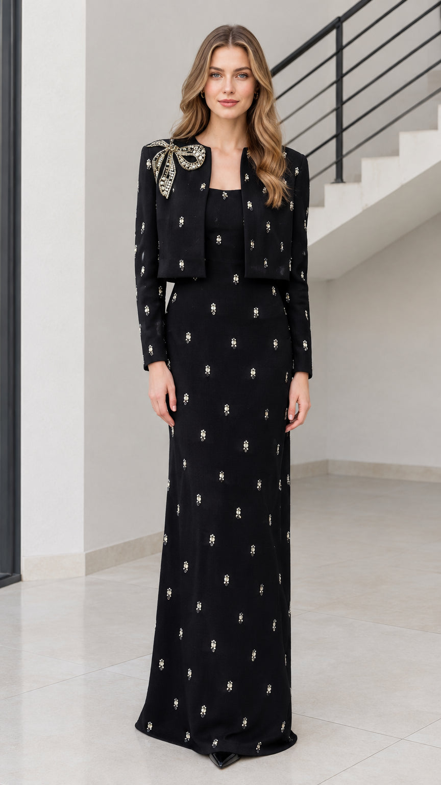 Front view of black rhinestone bow embellished maxi dress with matching cropped bolero jacket