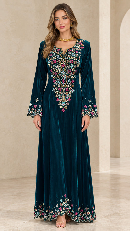 Front full-length view of woman wearing teal embroidered velvet maxi dress