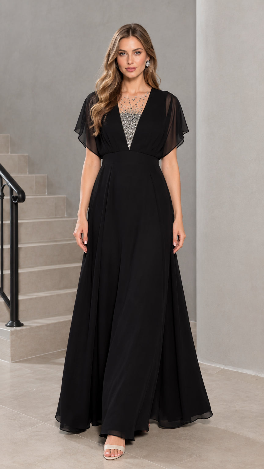 Front view of model wearing black flutter sleeve chiffon evening maxi dress with rhinestone illusion neckline