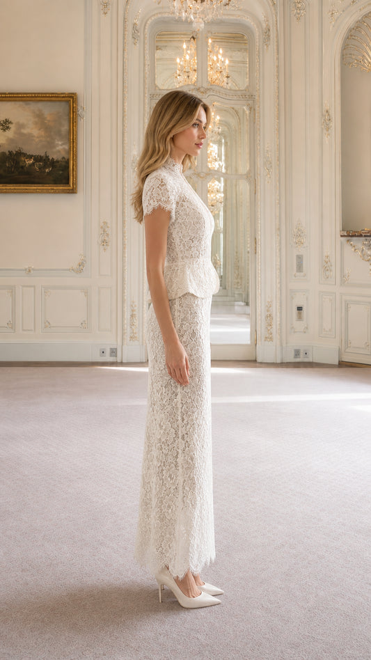 Side profile of woman wearing ivory lace peplum column maxi dress