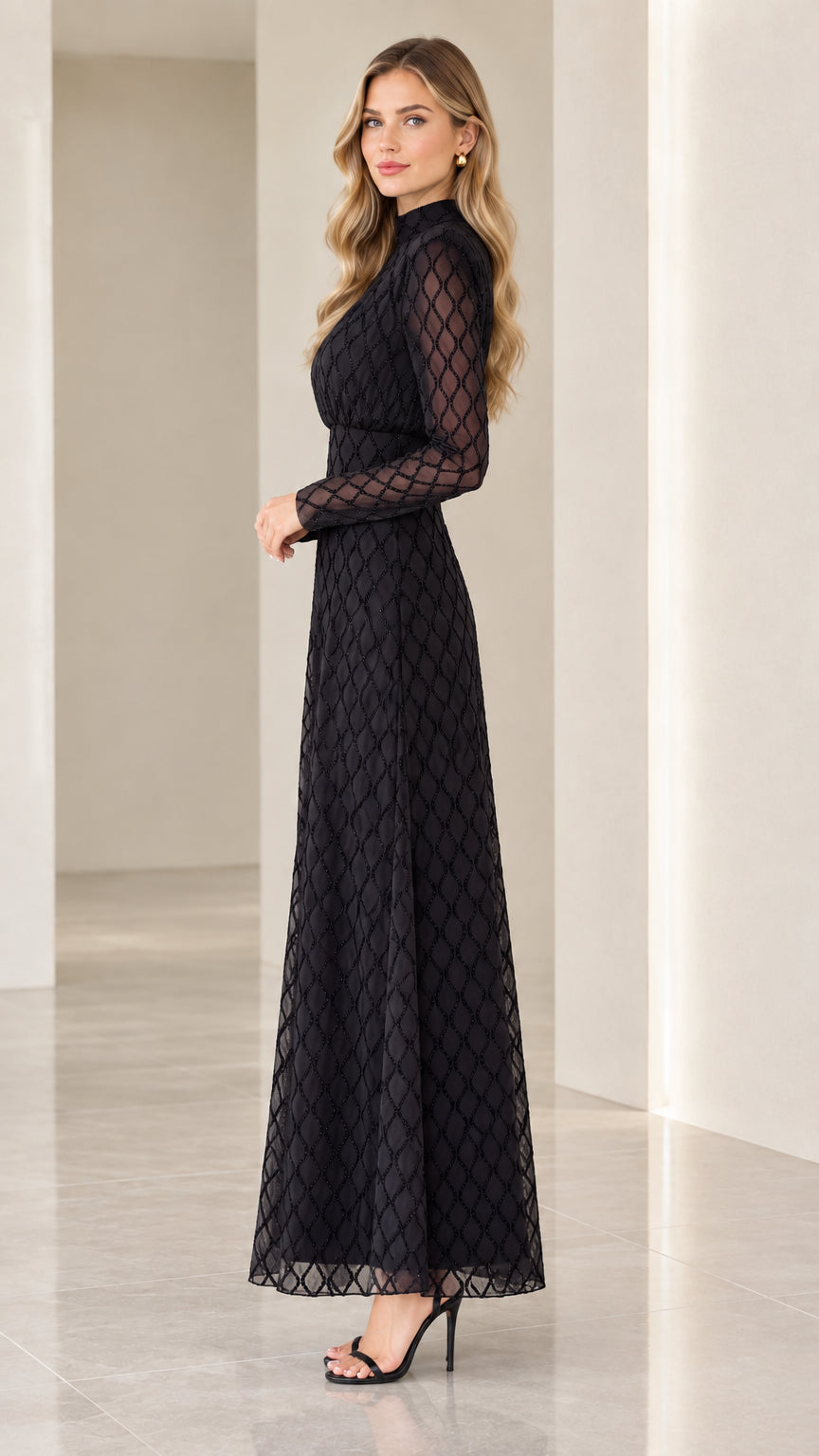 Side profile of woman wearing black textured diamond pattern maxi dress