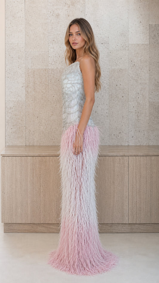 Side profile view of silver and pink feather one-shoulder evening gown
