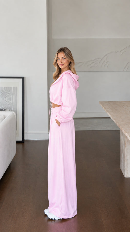 Side profile of model in pink loungewear set showing fluid pants drape