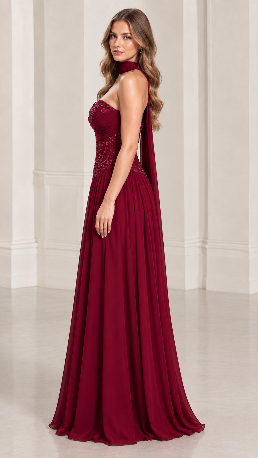 Side profile view of burgundy strapless chiffon formal dress