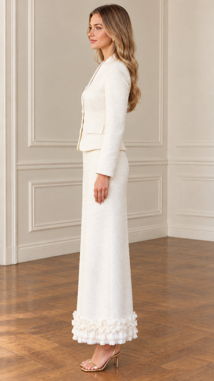 Side profile view of ivory tweed long skirt suit with tailored blazer