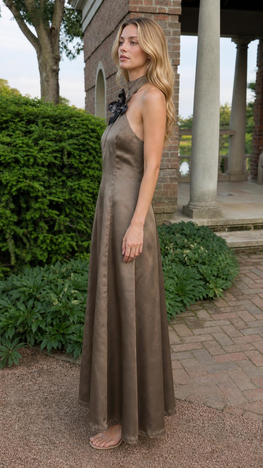 Side profile view of taupe satin dress in outdoor setting