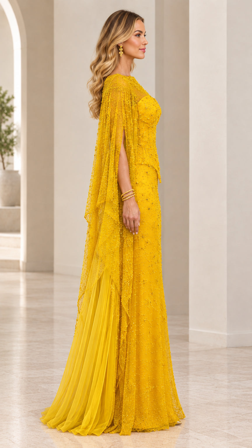 Side angle of Mustard Yellow formal maxi gown showing sweeping sheer cape sleeves