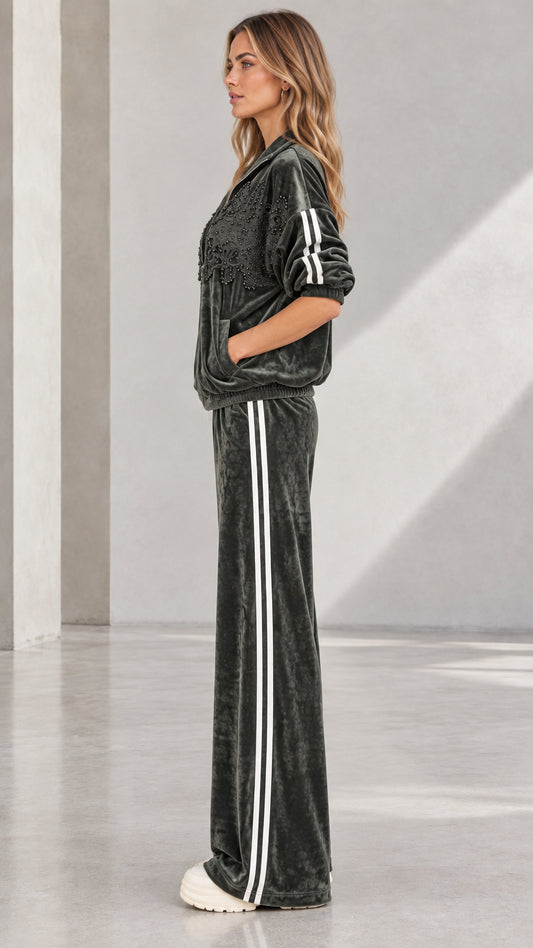 Side profile of woman in Dark Green velvet tracksuit showing sporty side stripes